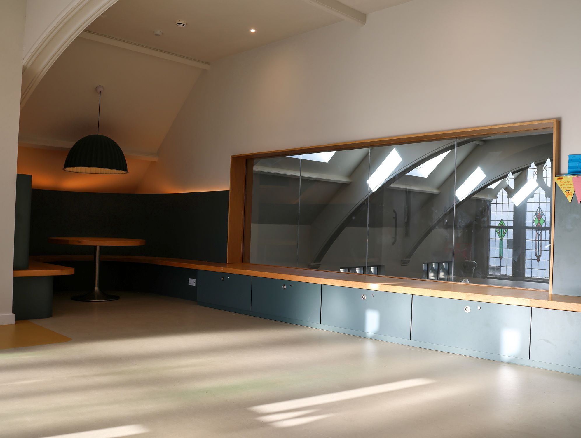 The upstairs room with a glass wall looking down into the hall